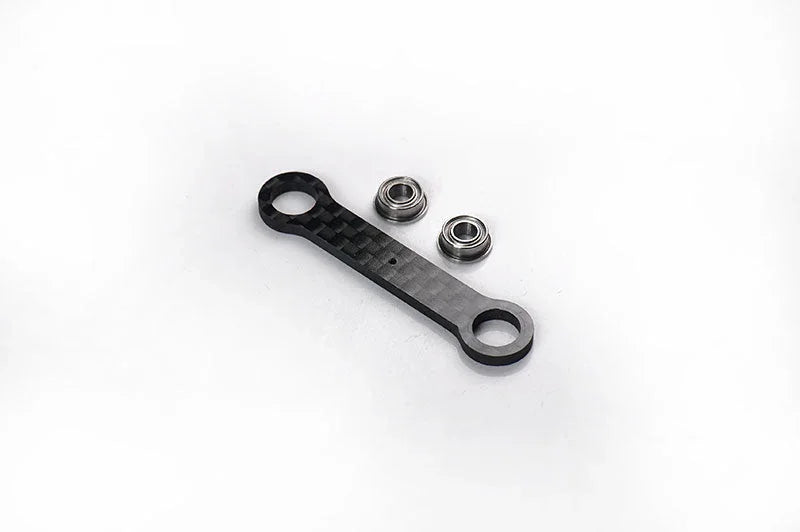 RC carbon fiber steering link with two metal ball bearings on white background