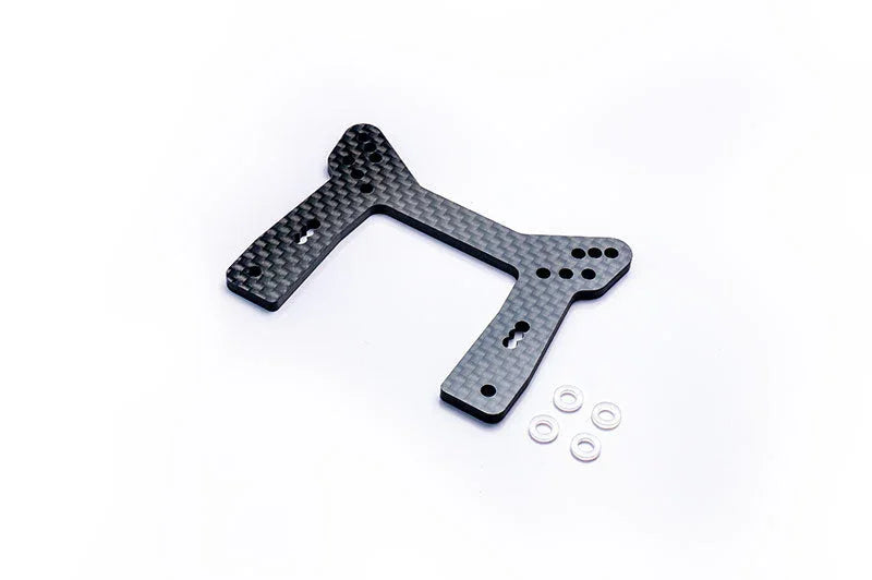 Carbon fiber RC car shock tower with four metal washers on a white background
