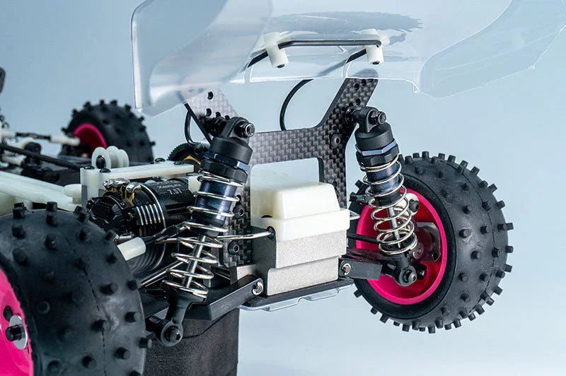 Close-up of RC car rear suspension, knobby tires, and shock absorbers for racing