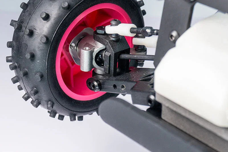 Close-up of RC car rear wheel with pink rim and detailed suspension parts