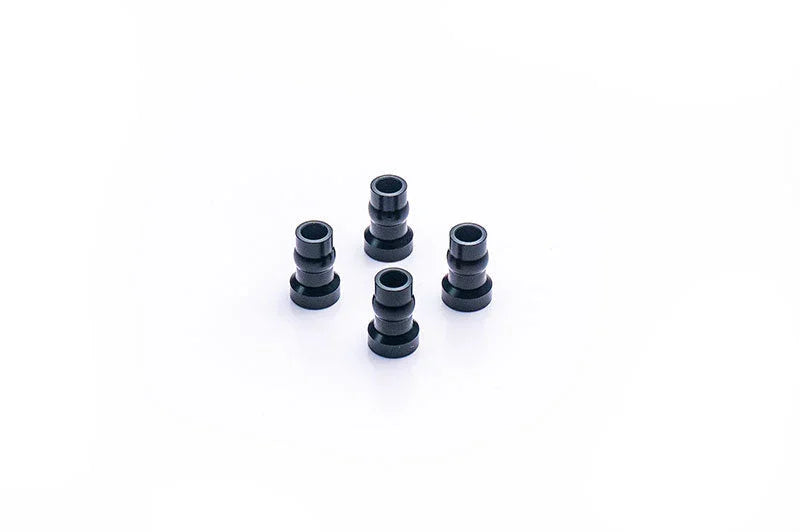 Set of four black RC car aluminum bushings on a white background