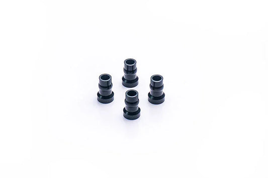 Set of four black RC car aluminum bushings on a white background
