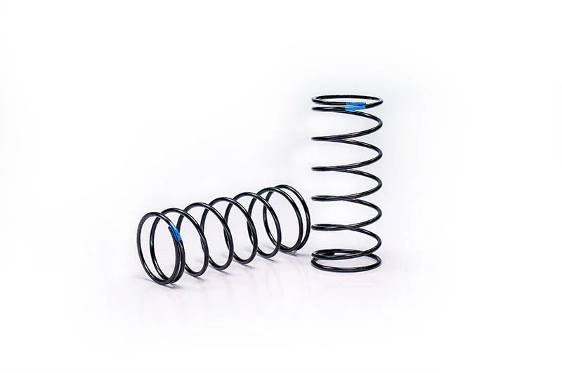 Pair of black RC car suspension springs on white background, close-up view