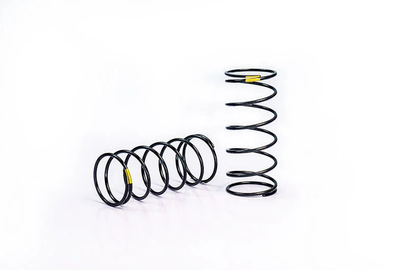 Two black RC car suspension springs with yellow markings on a white background