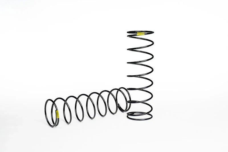 Two black RC car coil springs on white background, one standing upright, one lying down
