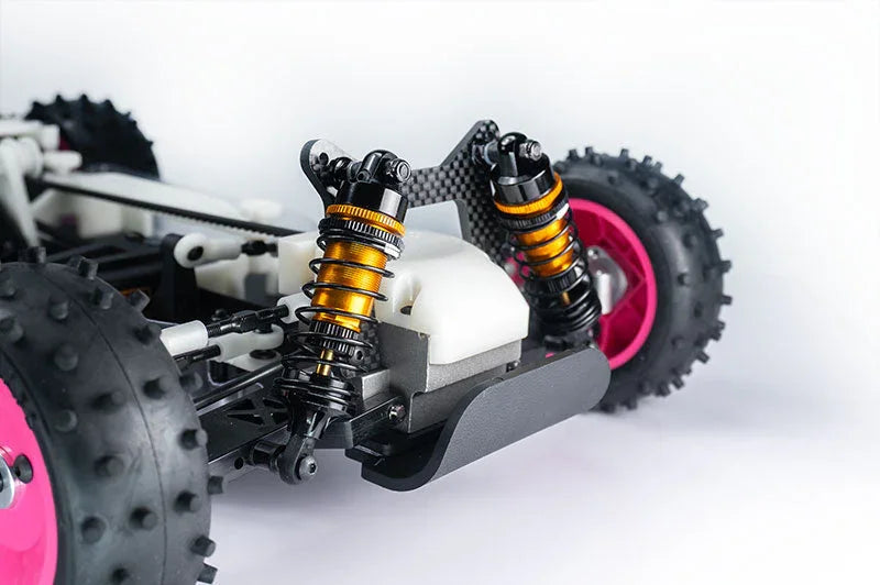Close-up of RC car rear suspension system with orange coilover shocks and knobby tires