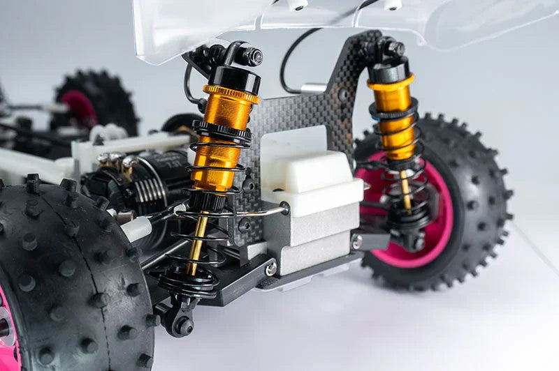 RC car rear suspension with gold shock absorbers and knobby tires for racing