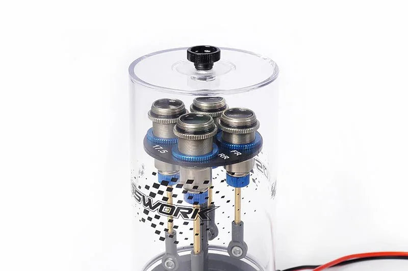 RC shock absorber air remover tool with clear acrylic chamber and four shocks inside