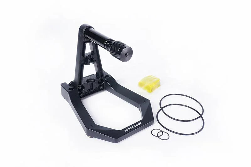 RC car tire balancer tool with stand and rings on white background