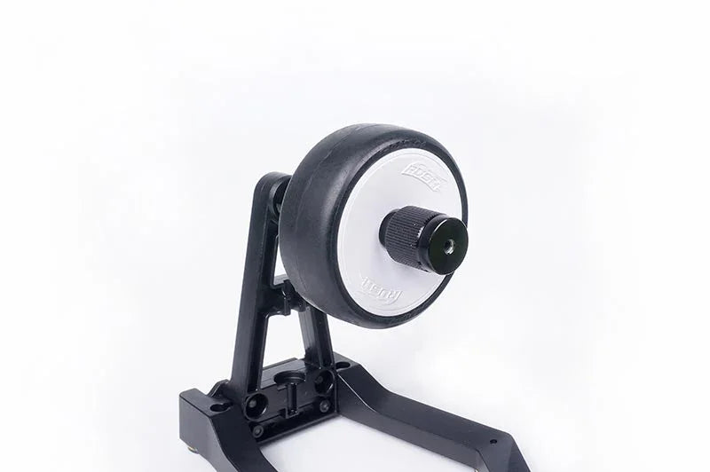 RC car tire balancer with mounted tire and black adjustable stand for hobby tools