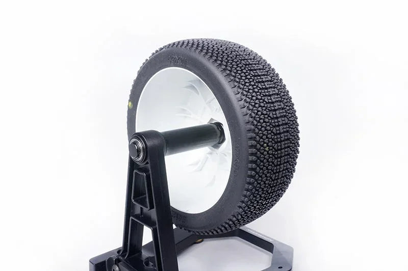RC buggy tire with knobby tread on display stand, ideal for off-road remote control racing.