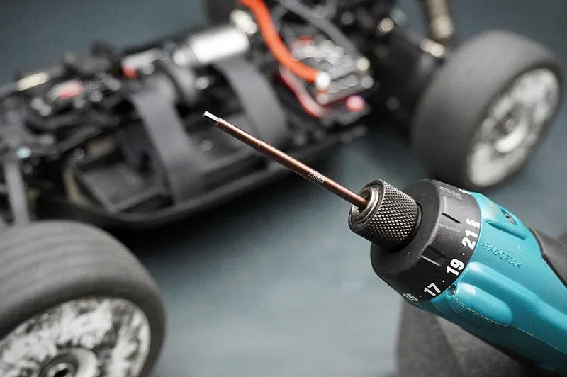 Koswork RC car hex driver tool in electric drill, close-up, car chassis in background