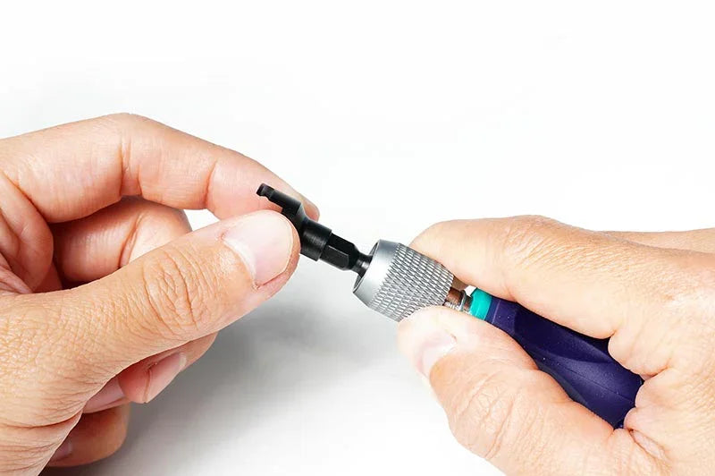 Hands using an RC car tool with precision tip for model assembly or maintenance
