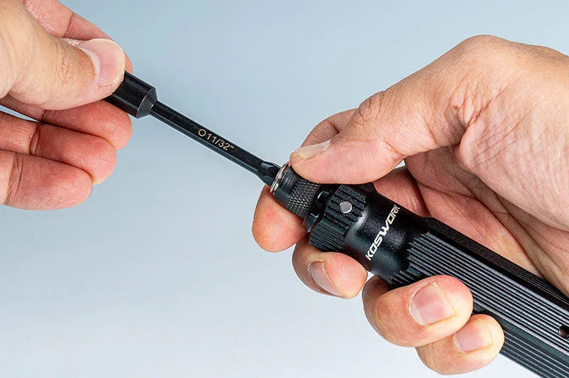 Hands changing a 11/32 inch RC tool bit on a precision black handle