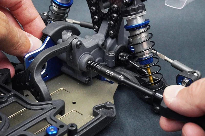 Koswork 5.5mm RC car tool in use with detailed chassis and suspension parts visible
