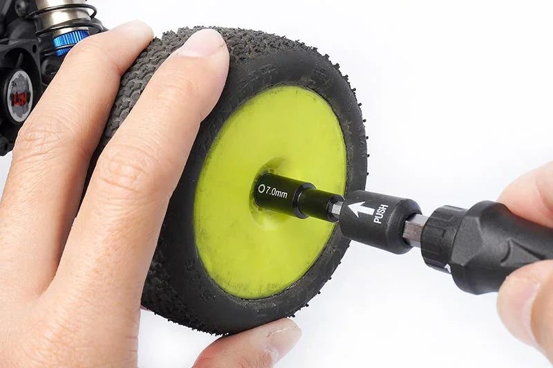 Koswork RC car 7.0mm hex wheel wrench tool being used on a yellow wheel.