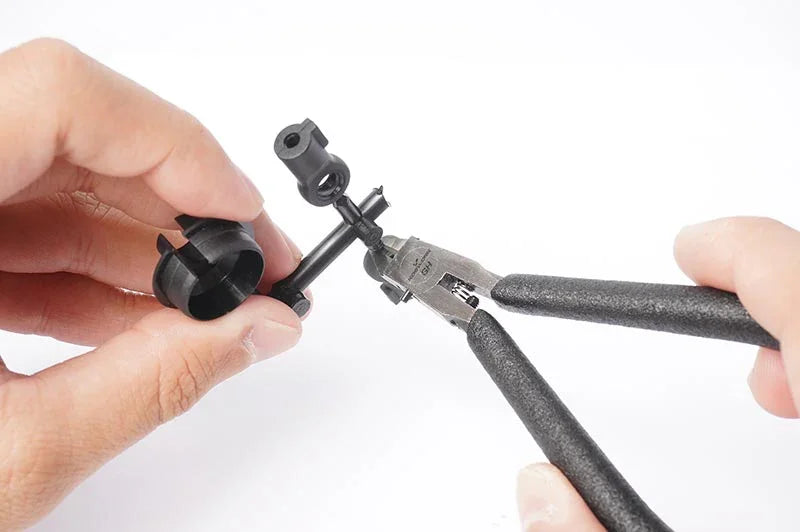 Koswork RC plastic parts being cut with side cutters, close-up tool accessory for RC cars