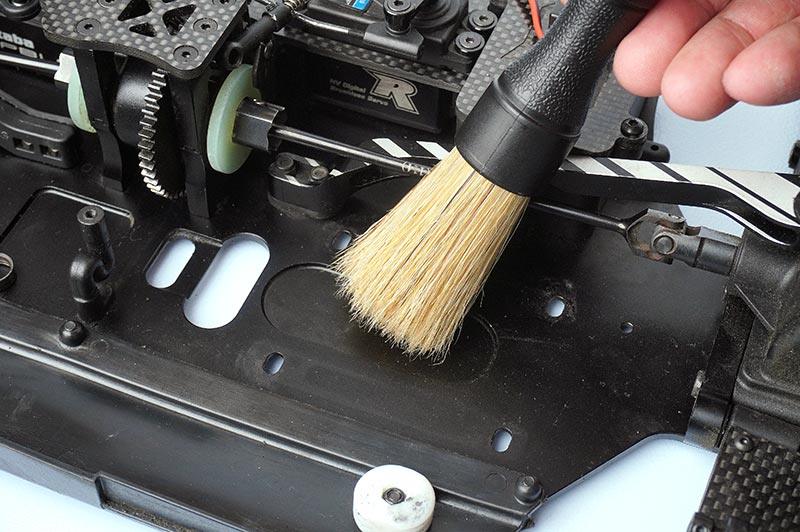 Koswork RC cleaning brush with natural bristles used on RC car chassis, detail view
