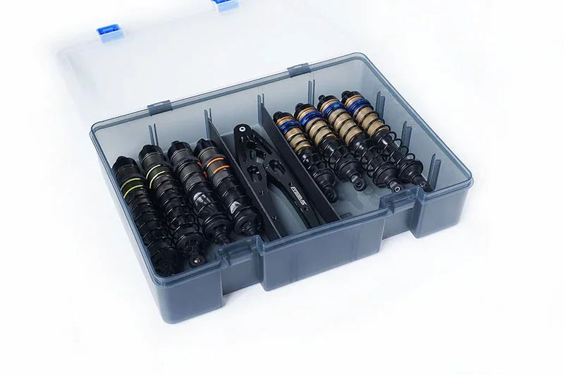 RC shock absorbers and tools organized in a transparent plastic storage case with dividers