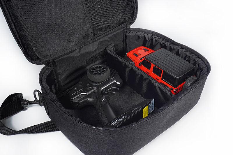 RC transmitter and red RC car stored in a padded black carry case with adjustable dividers