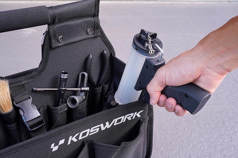 Koswork RC pit bag KOS32236V2, black fabric with tool pockets, holding RC car accessories.