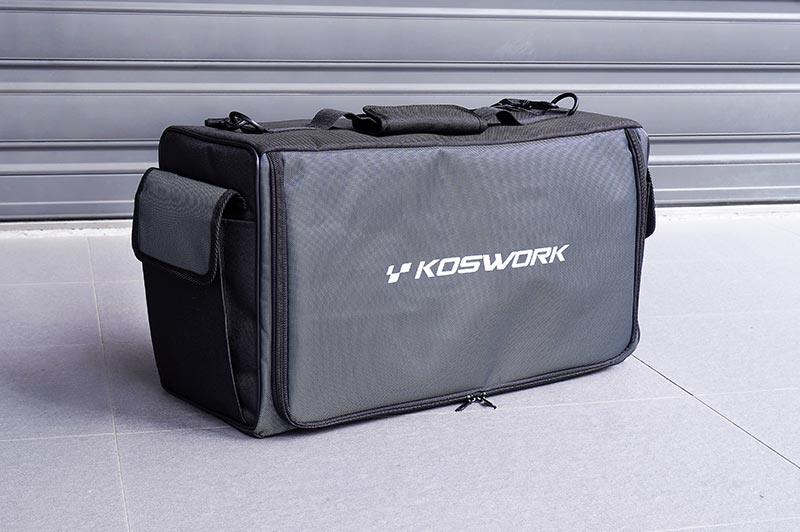 Large black Koswork RC pit bag with side pockets on tiled floor, ideal for hobby tools storage.