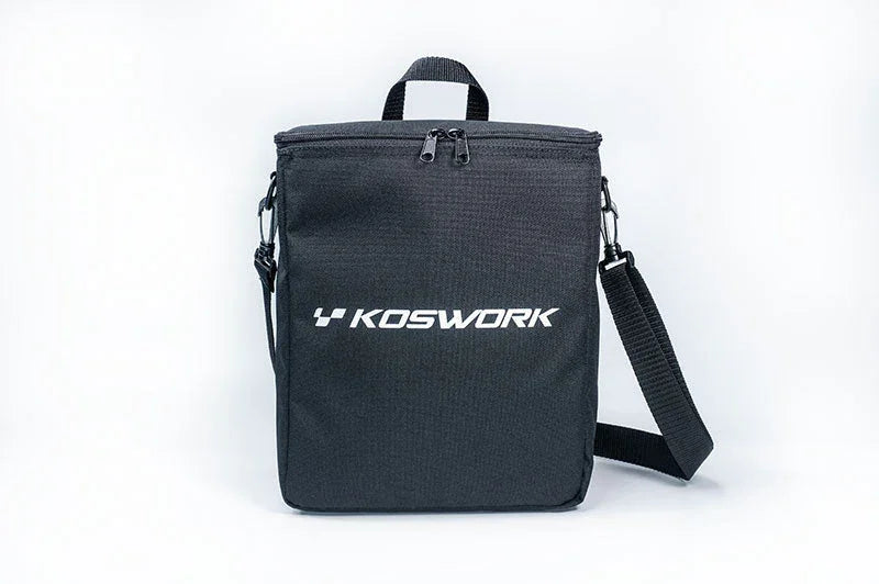 Black Koswork RC pit bag with shoulder strap and top zipper, isolated on white background