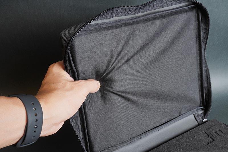 Hand stretching flexible black RC pit bag divider for storage and organization