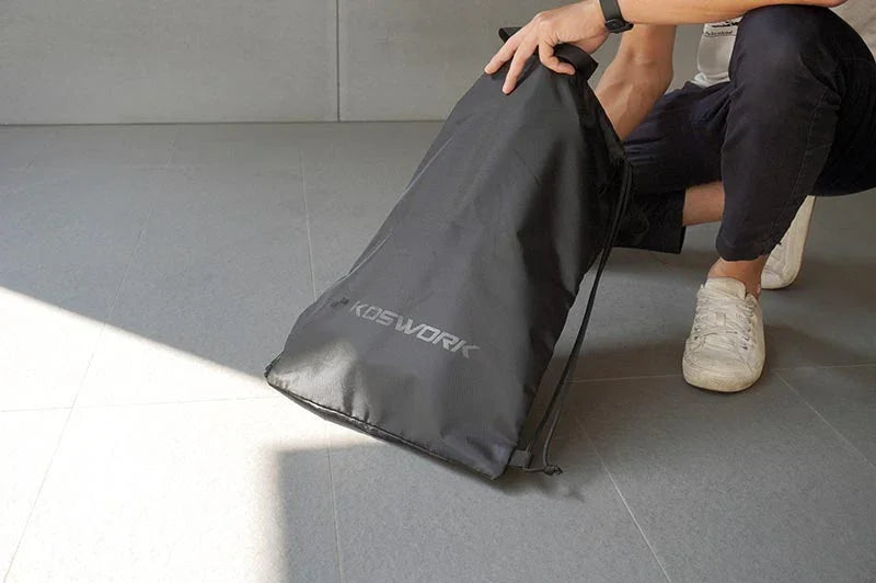 Koswork black RC car carrying bag, large size, durable material, shown held on the floor.