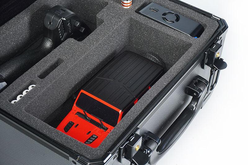 Foam-lined carrying case with RC car, controller, and accessories securely organized