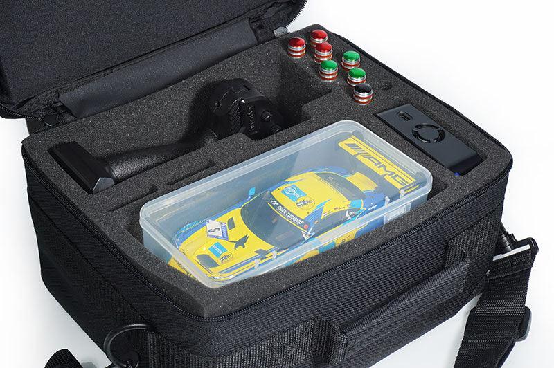 RC car storage bag with foam compartments, yellow RC car, remote, and accessories inside.