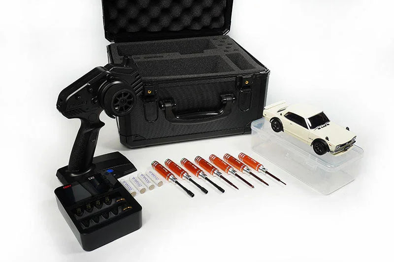 RC car kit with transmitter, tool set, charger, batteries, case, and model car on white background