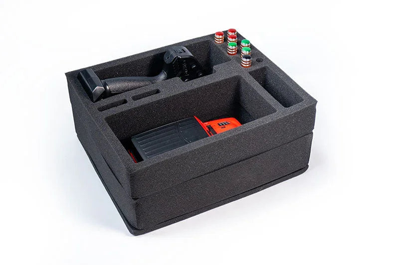 RC car pit foam organizer with remote control and spare parts compartments