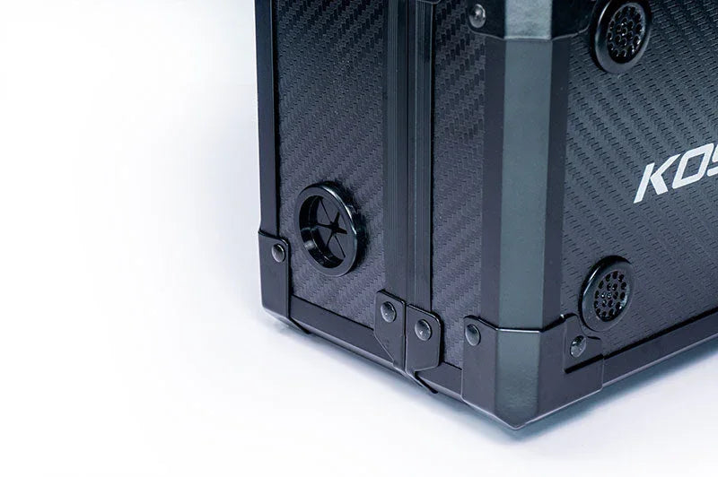 Close-up of a black carbon fiber RC parts storage case with reinforced corners
