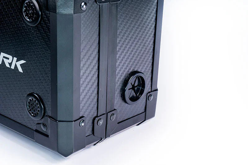 Close-up of a sturdy black RC pit box or tool case with carbon fiber texture and reinforced corners