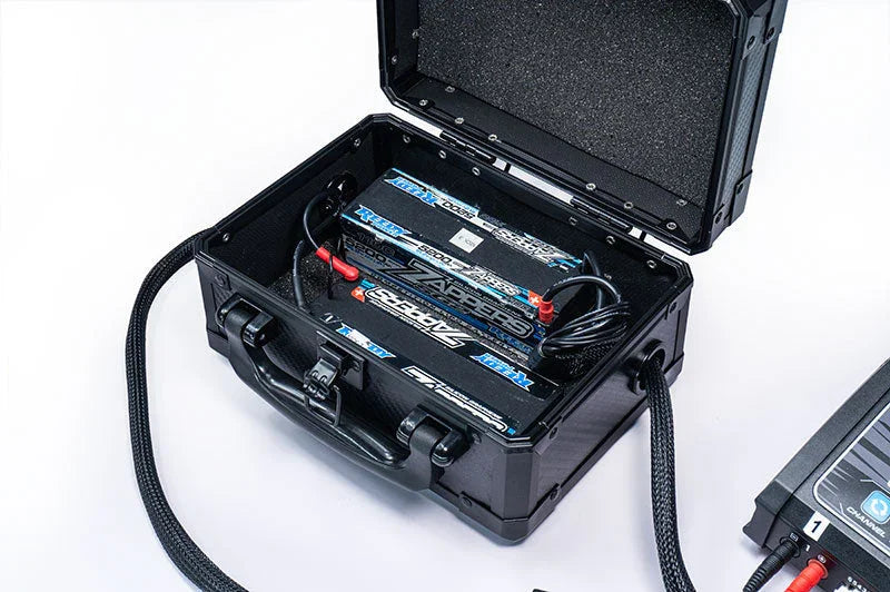 Hard protective case storing RC battery packs with foam lining and charging cables