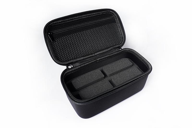 Black RC tool storage case with foam insert and mesh zipper pouch, open on white background