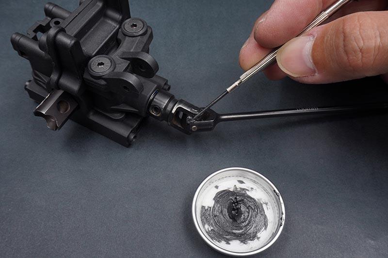 Koswork RC car accessory KOS50008-7 in black, lubricant application on steering part