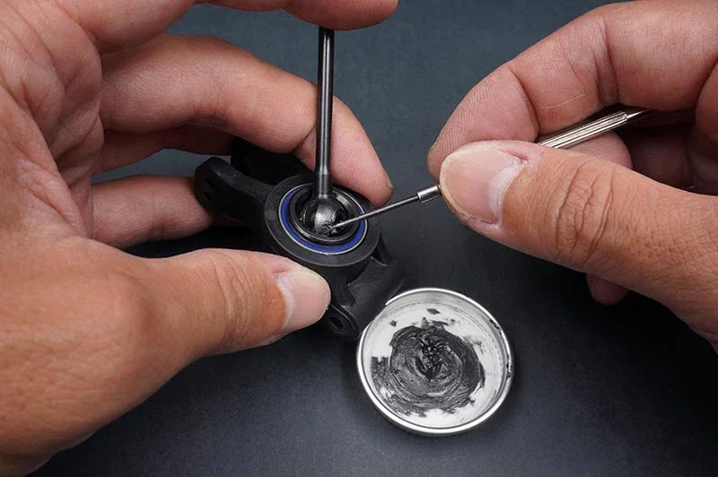 Koswork RC car bearing maintenance with tools, grease, and black plastic part, product KOS50008-8