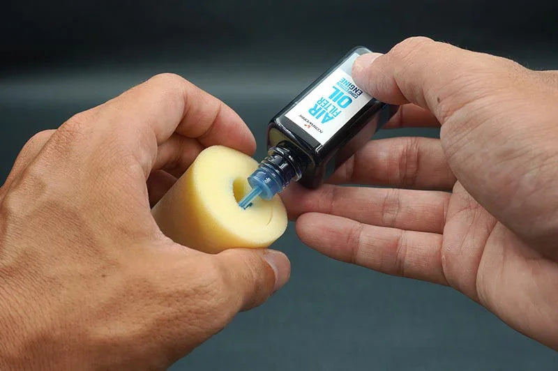 Koswork RC air filter oil being applied to yellow foam filter, product KOS50021.