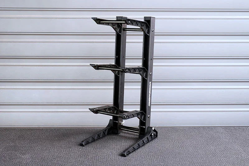 Three-tier black RC car display stand with sturdy frame on carpeted floor