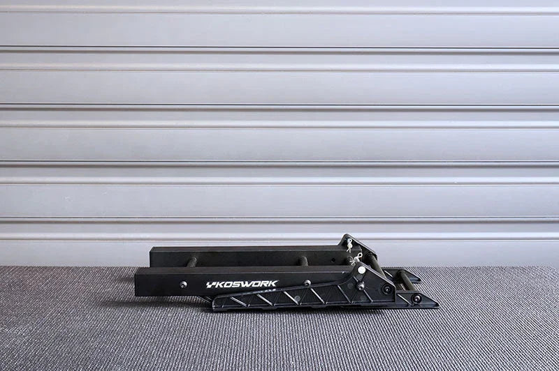 Black foldable RC car stand with Koswork logo on a textured gray surface